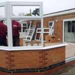 Building the brick conservatory base and installing the first uPVC window frames