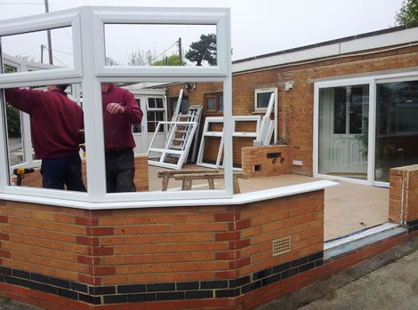 Building the brick conservatory base and installing the first uPVC window frames