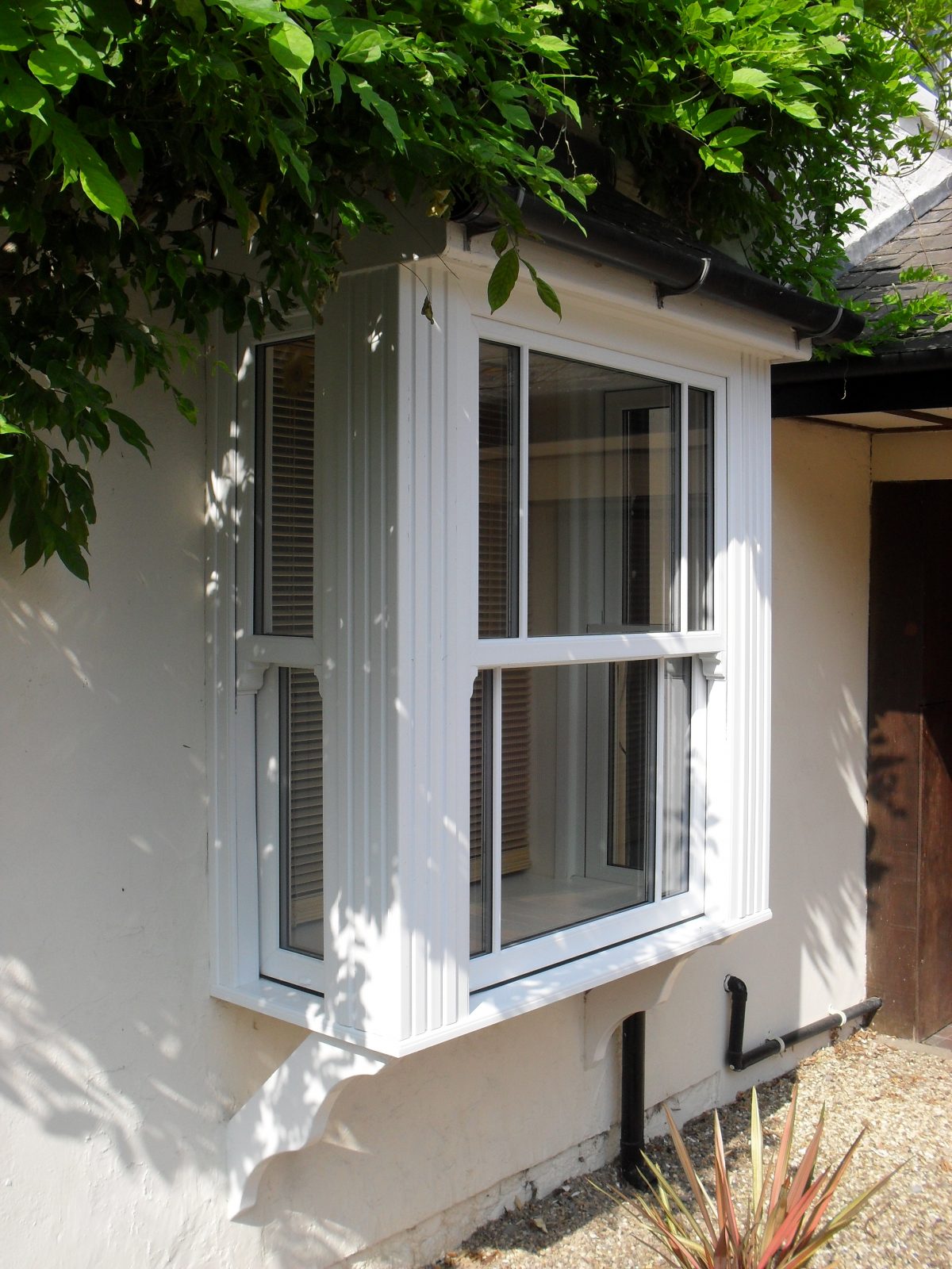 a white upvc bay window- sash windows are secure