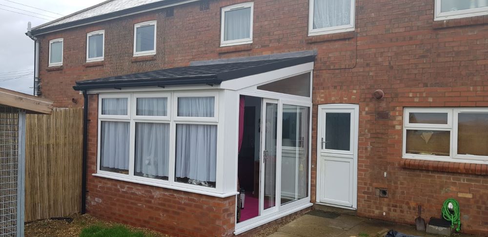 tiled conservatory roof extension on side of house